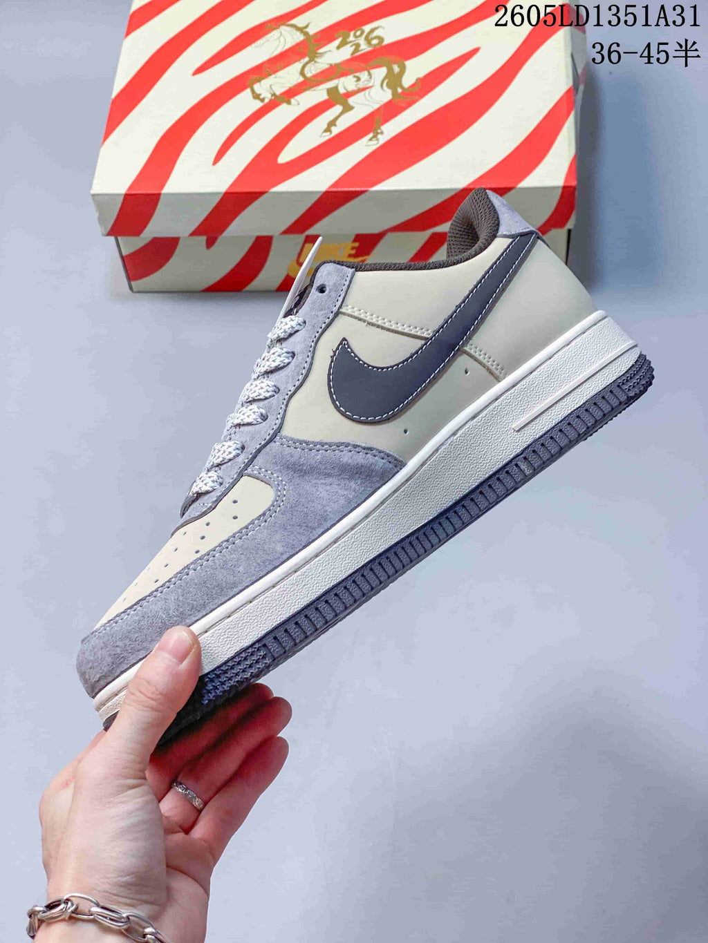 Side profile showing gray Swoosh detailing and off-white panels