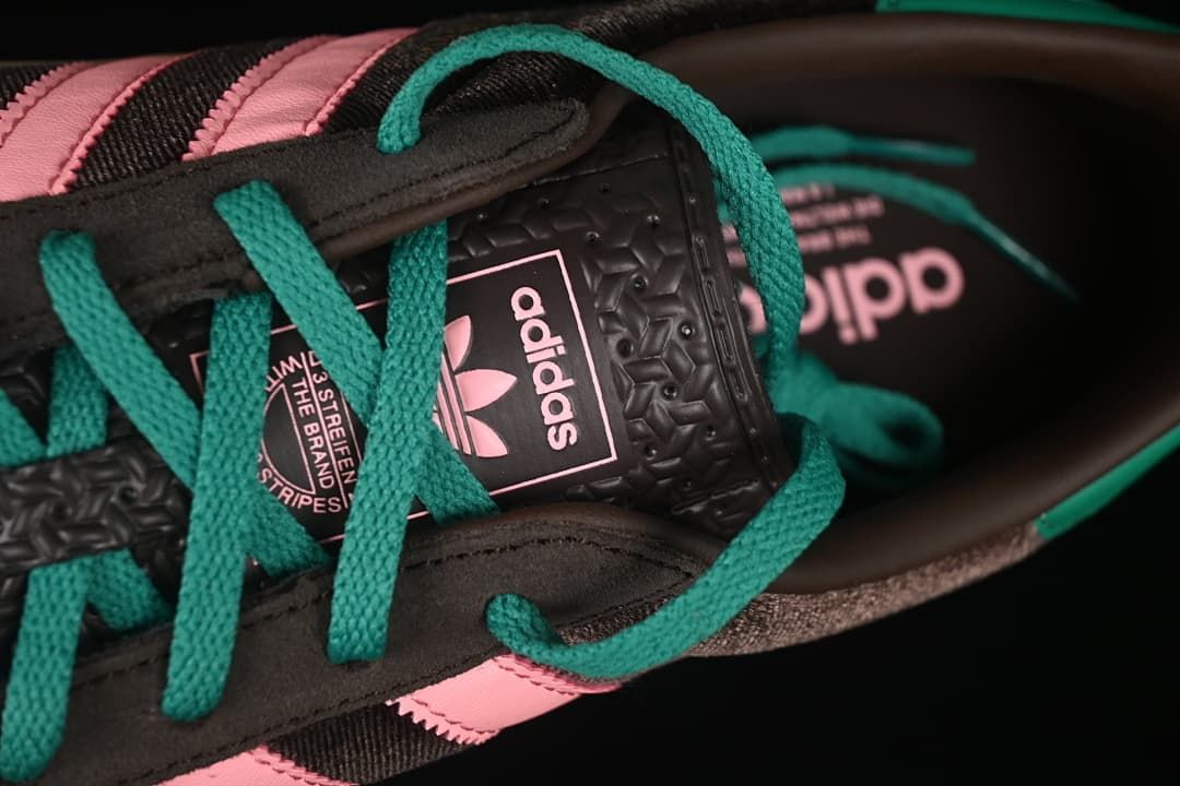 Close-up of teal laces and the adidas tongue label.