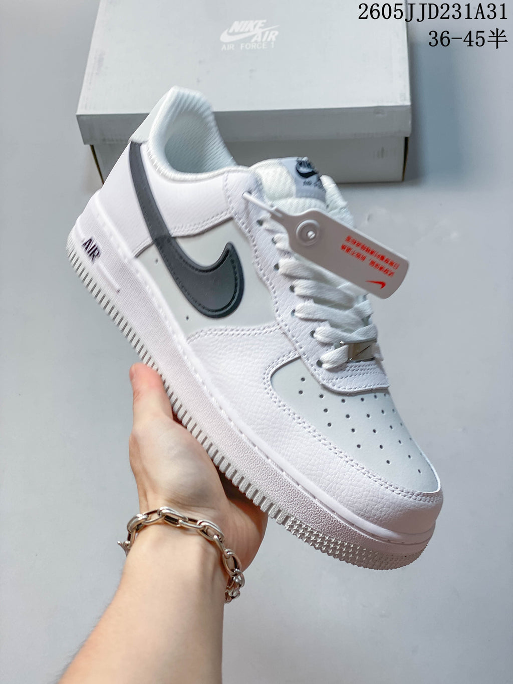 Side view of a white Nike Air Force 1 Low sneaker with dark Swoosh and white outsole
