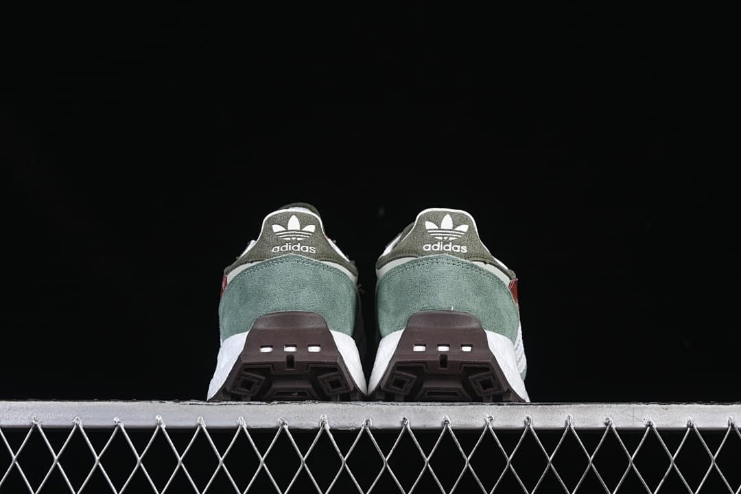 Rear view of both sneakers and their dark outsoles