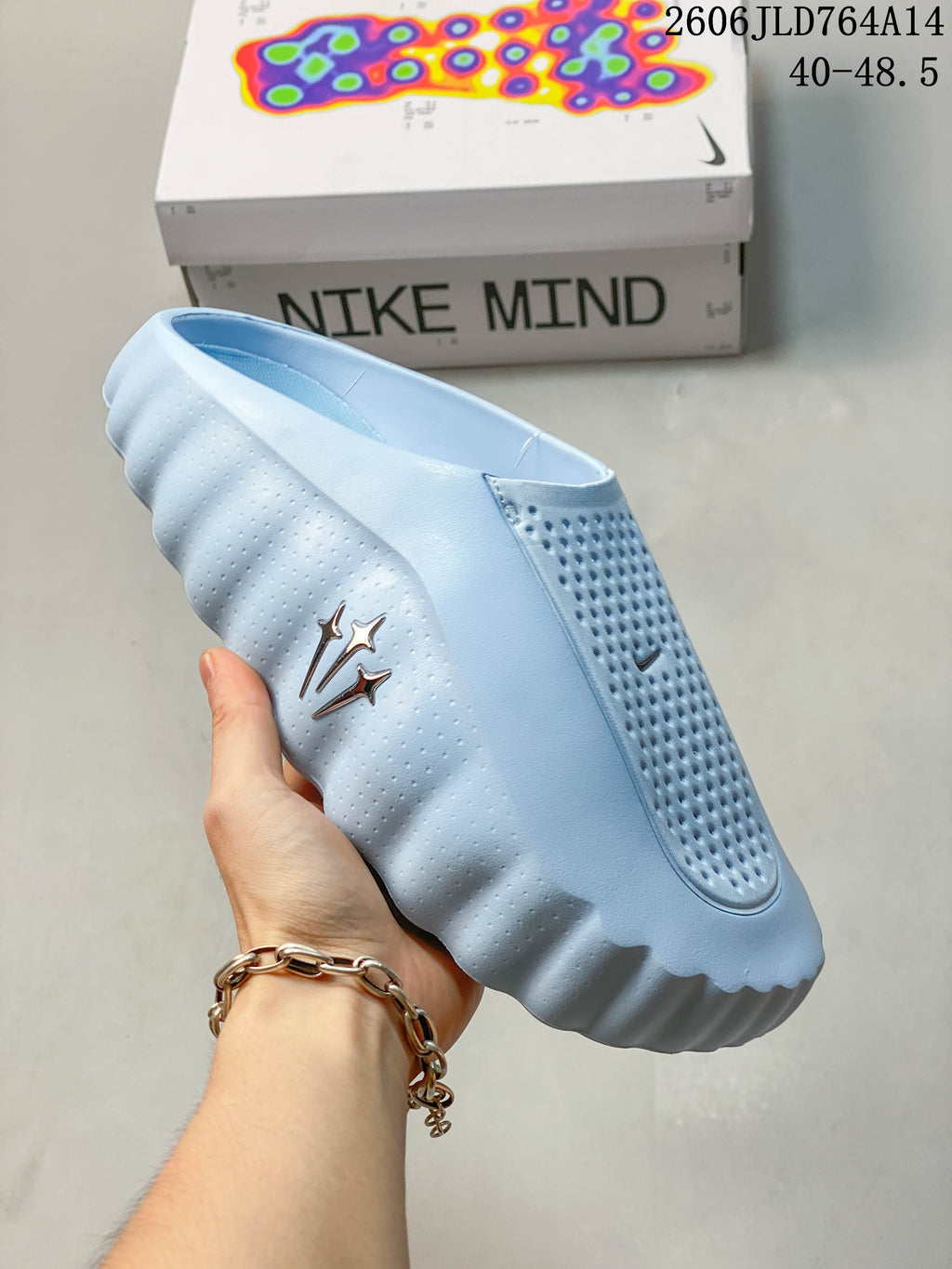 Side view of the light blue mule with Nike and NOCTA design marks
