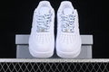 Front view of white low-top sneakers with black-speckled laces and perforated toe panels