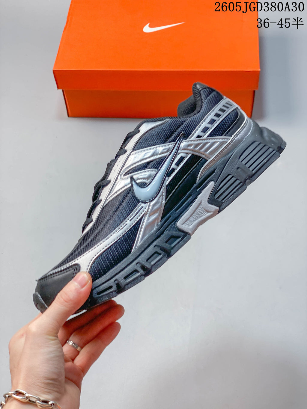 Side profile of a charcoal and silver Nike Initiator sneaker