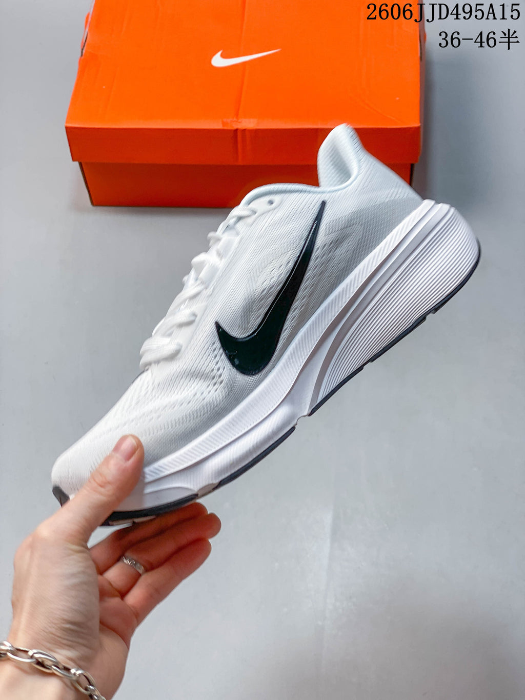 Side view of a white Nike Pegasus 42 running shoe with a dark Swoosh