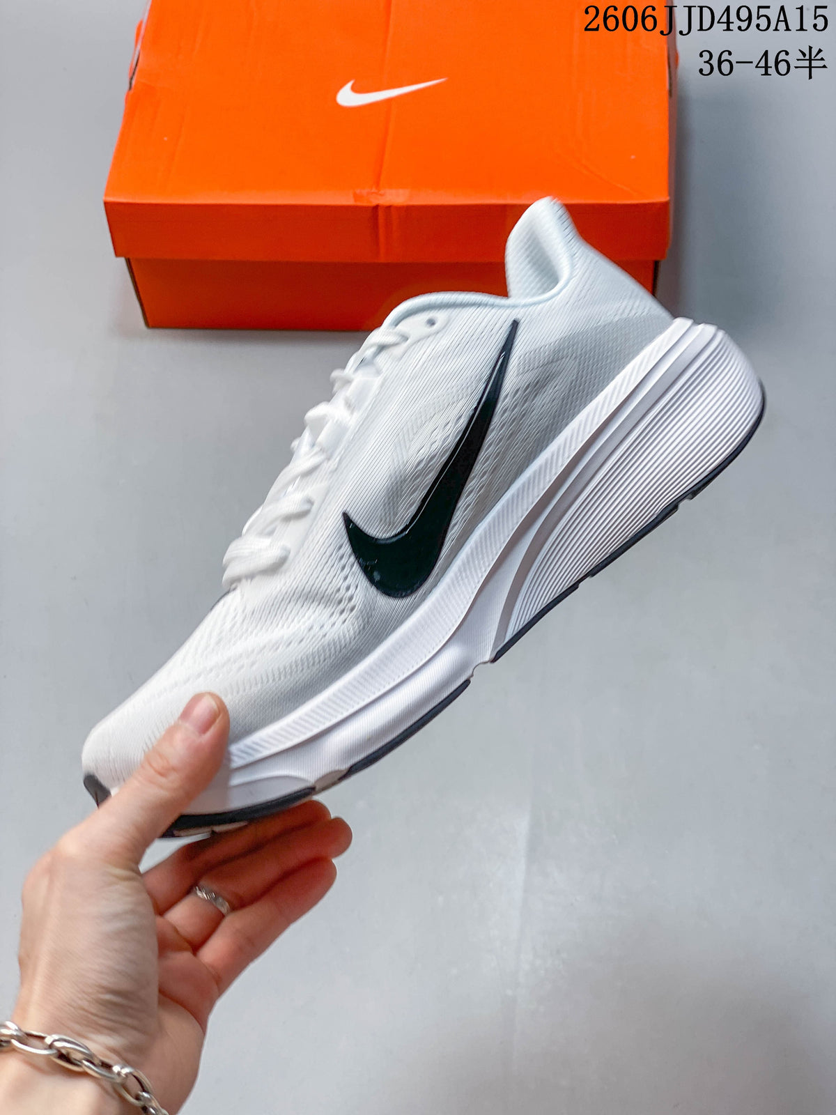 Side view of a white Nike Pegasus 42 running shoe with a dark Swoosh