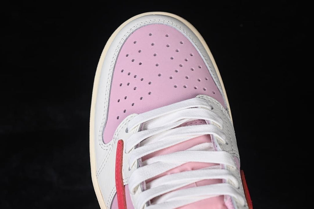 Top-down view of the perforated pink toe and white laces.