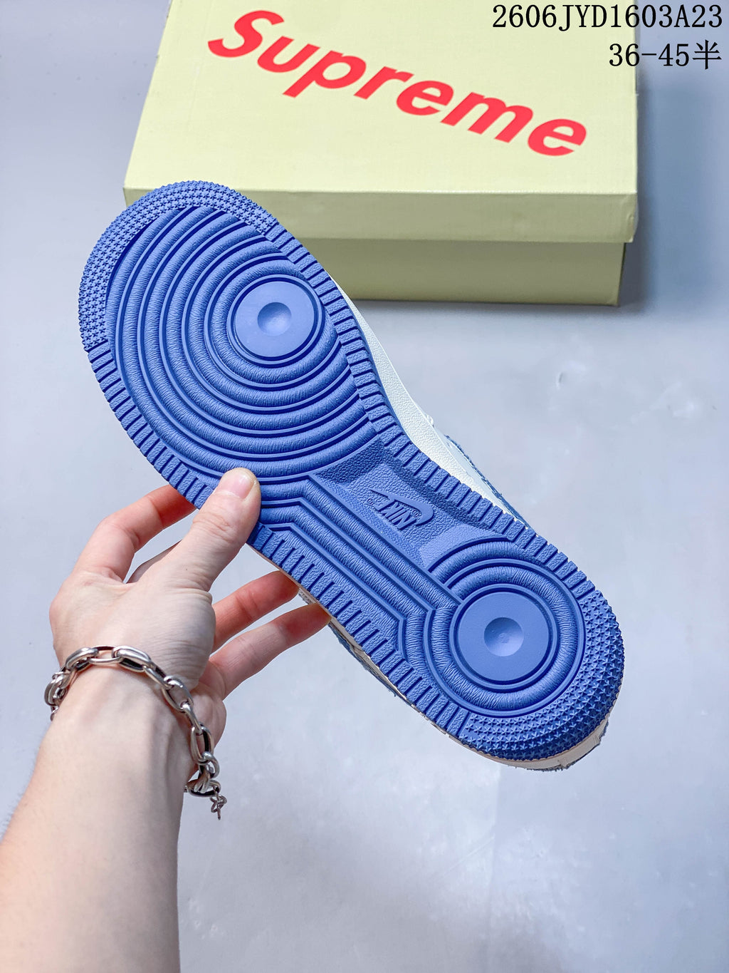 Close-up of the blue textured outsole and circular tread pattern