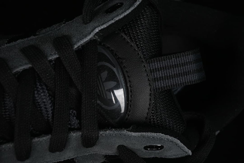 Close-up of the tongue, laces and trefoil detail