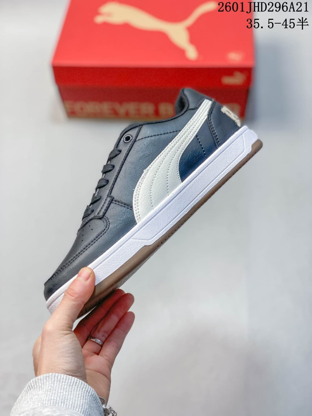 Side profile of a navy PUMA Caven 2.0 Retro sneaker with a white side stripe and white midsole