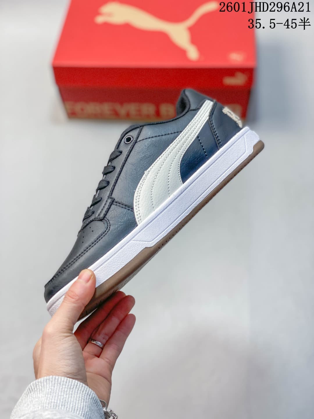 Side profile of a navy PUMA Caven 2.0 Retro sneaker with a white side stripe and white midsole