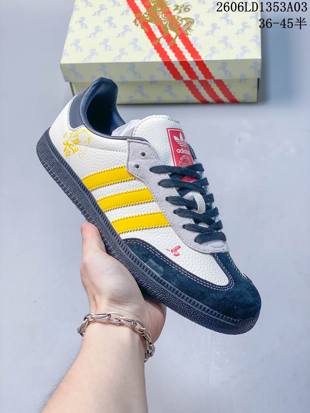 Angled view of the white, yellow and navy sneaker with horse-themed decorative accents.