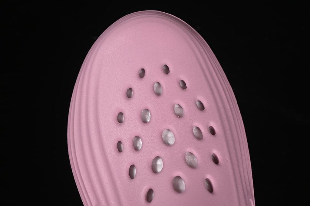 Top-down close-up of the perforated pink upper.