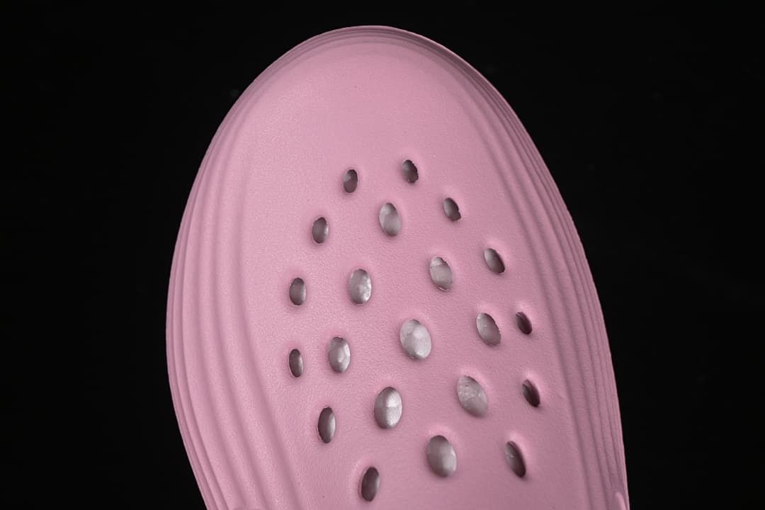 Top-down close-up of the perforated pink upper.