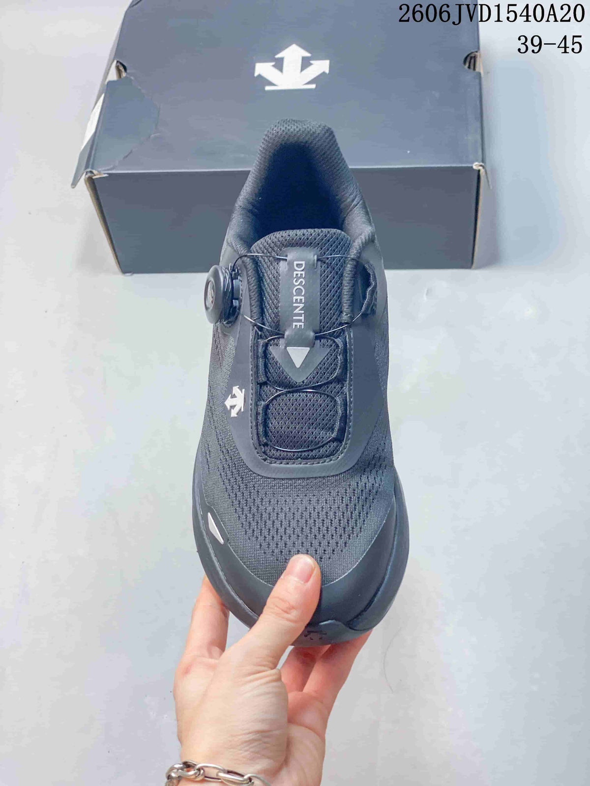 Top view of a charcoal gray Descente sneaker with a dial-style closure