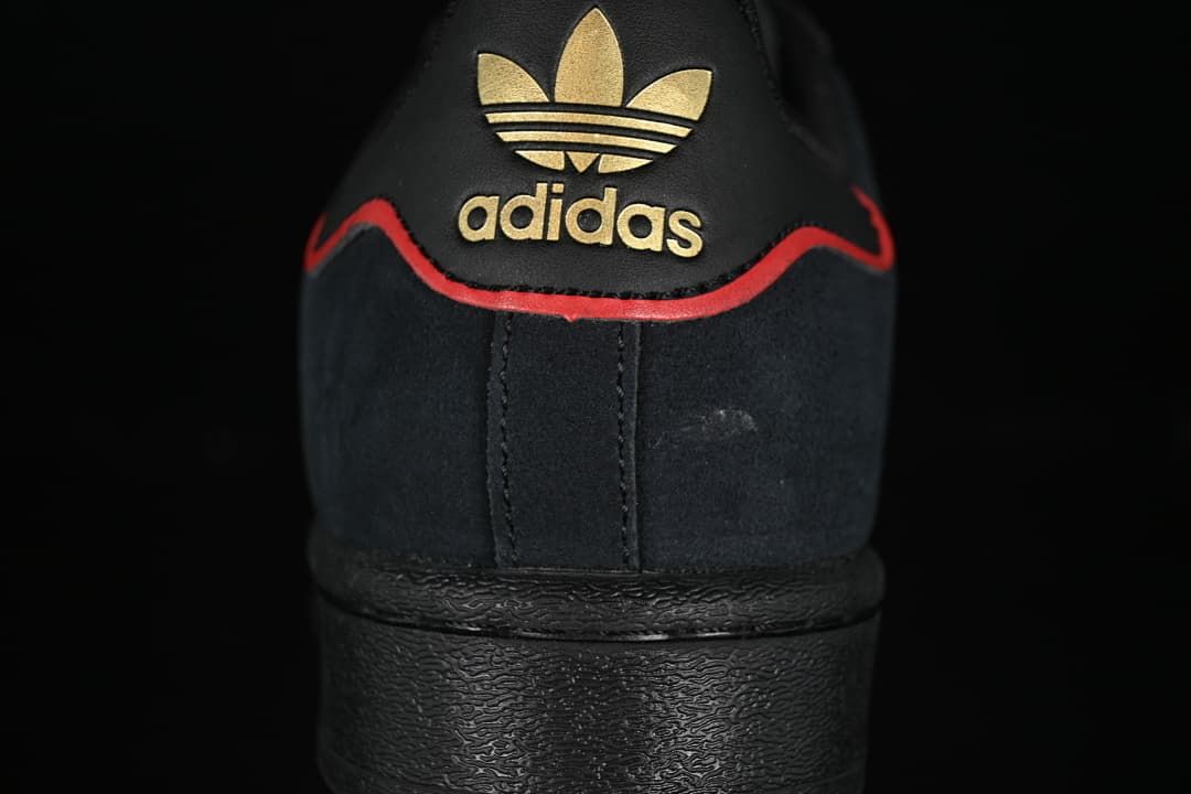 Rear view showing gold-tone adidas branding and red heel trim