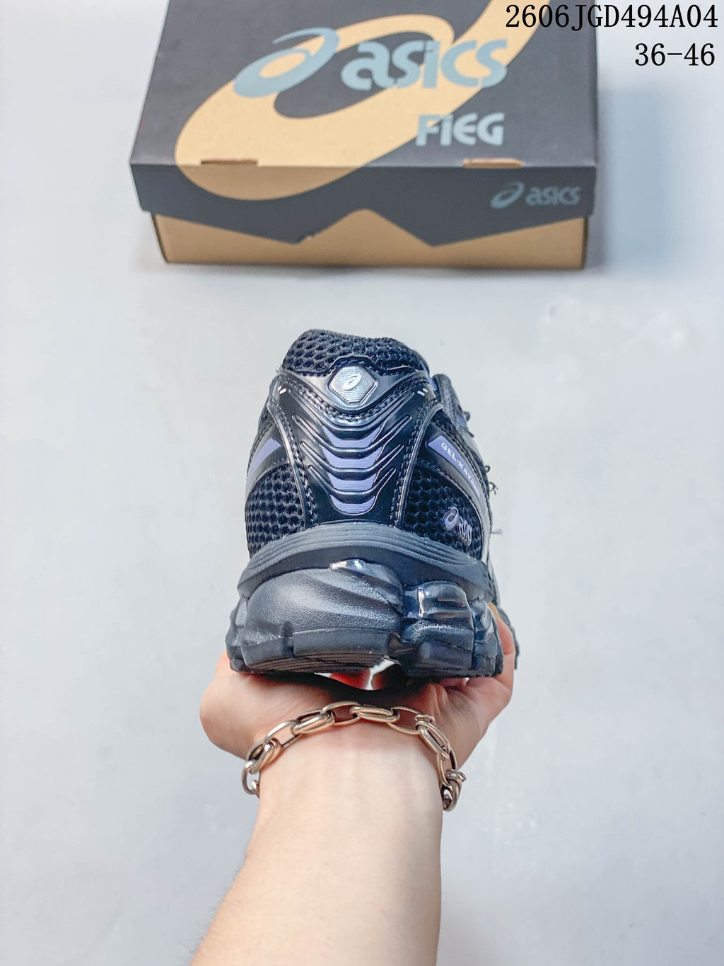Rear view of the dark gray sneaker highlighting the heel and outsole