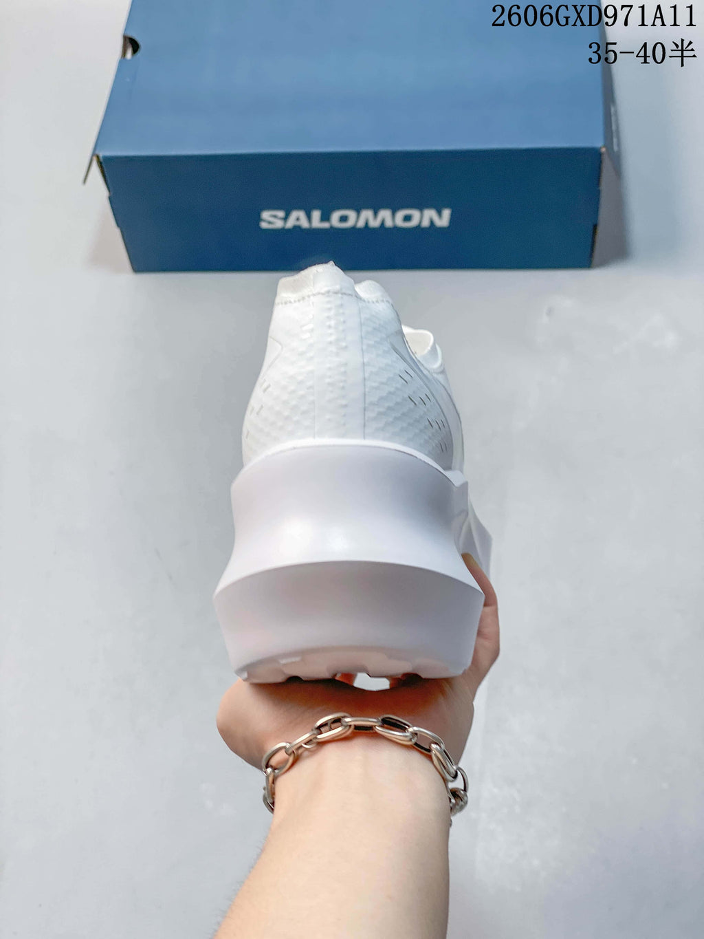 Rear view of a white sneaker showing the heel and sculpted sole