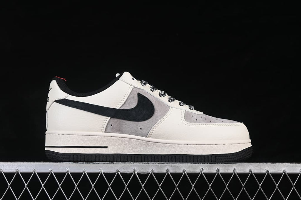 Side profile of a white, grey, and black low-top sneaker with patterned laces.