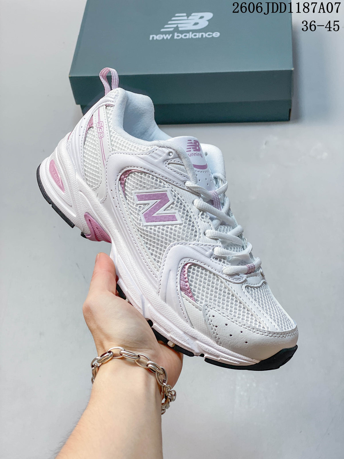 Angled side view of a white and pink New Balance 530 sneaker