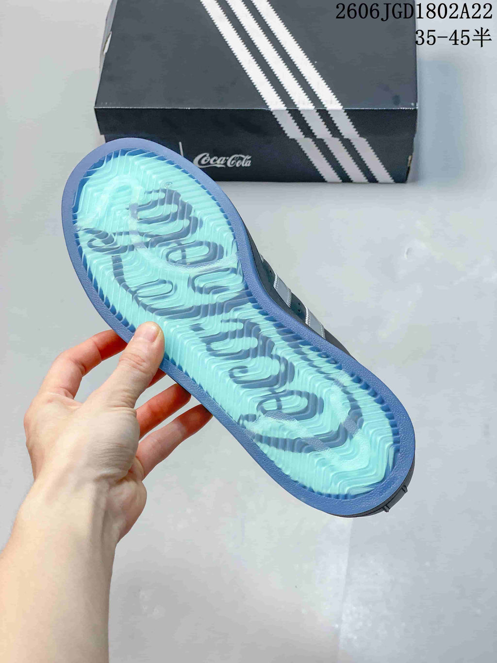 Close-up of the sneaker outsole showing a pale blue and teal patterned tread.