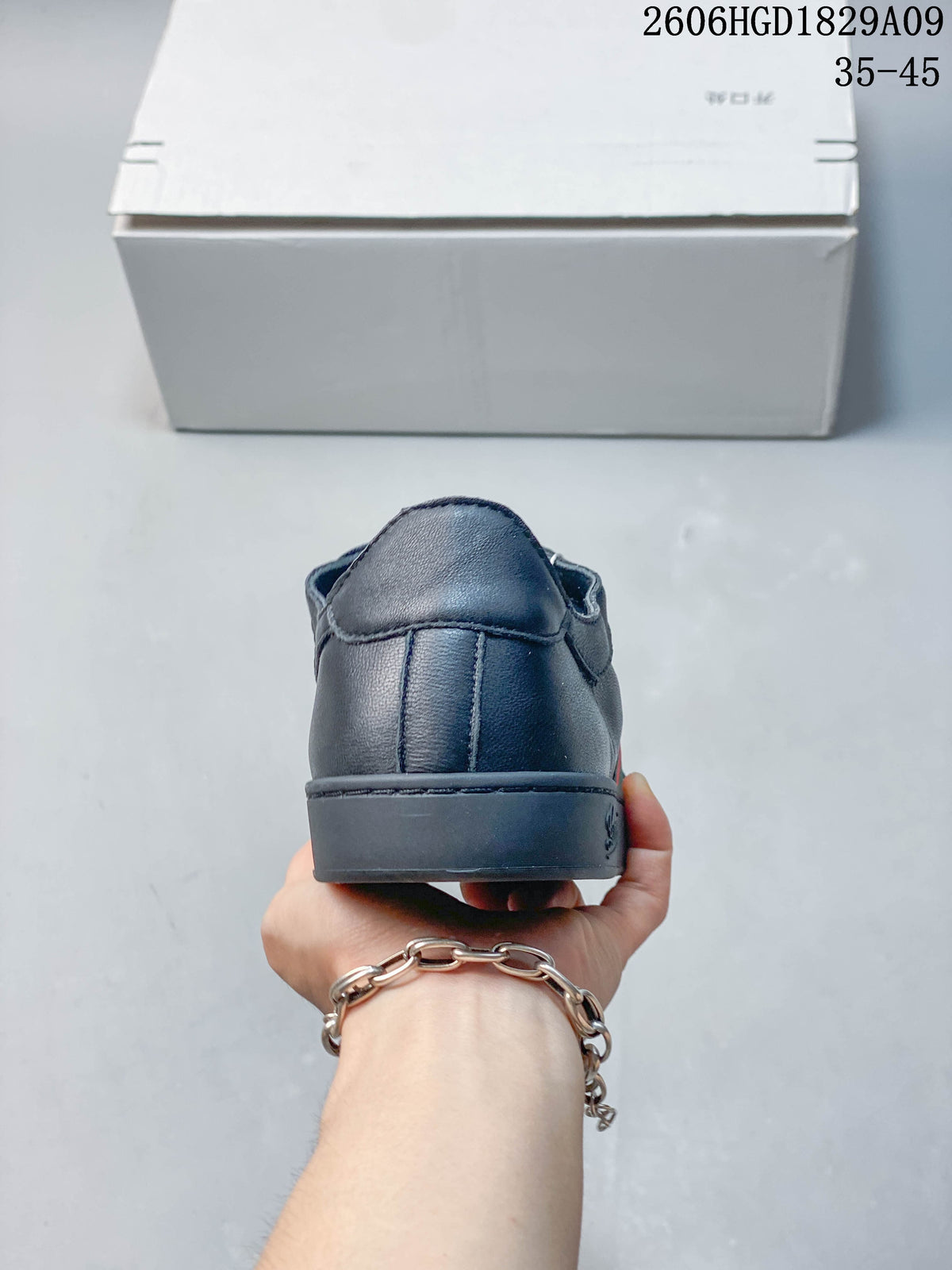 Rear view of a dark navy sneaker with a tonal heel and sole.