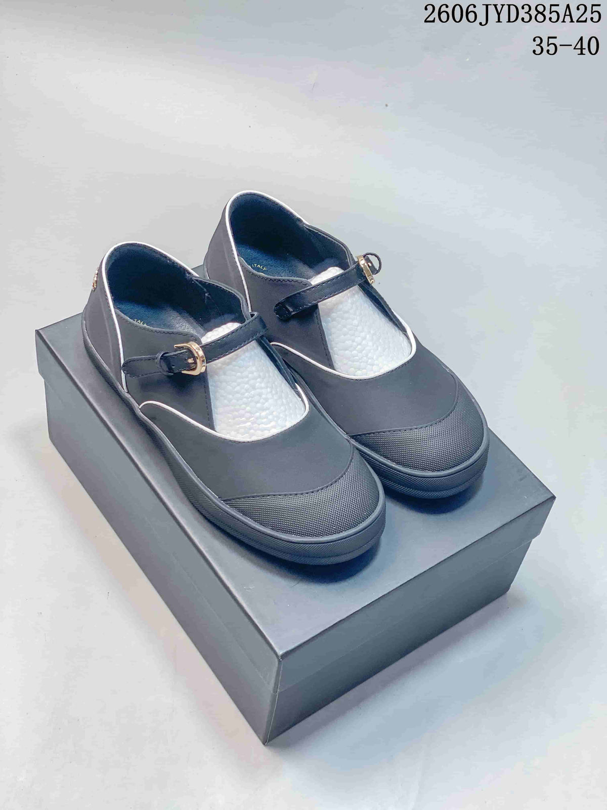 Pair of dark gray Mary Jane flats with white piping, textured toe caps, and buckle straps; size range 35–40 shown.