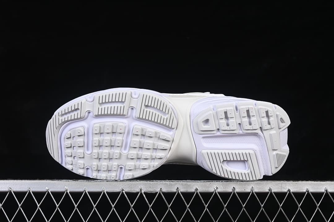 Underside view showing the patterned sneaker outsoles