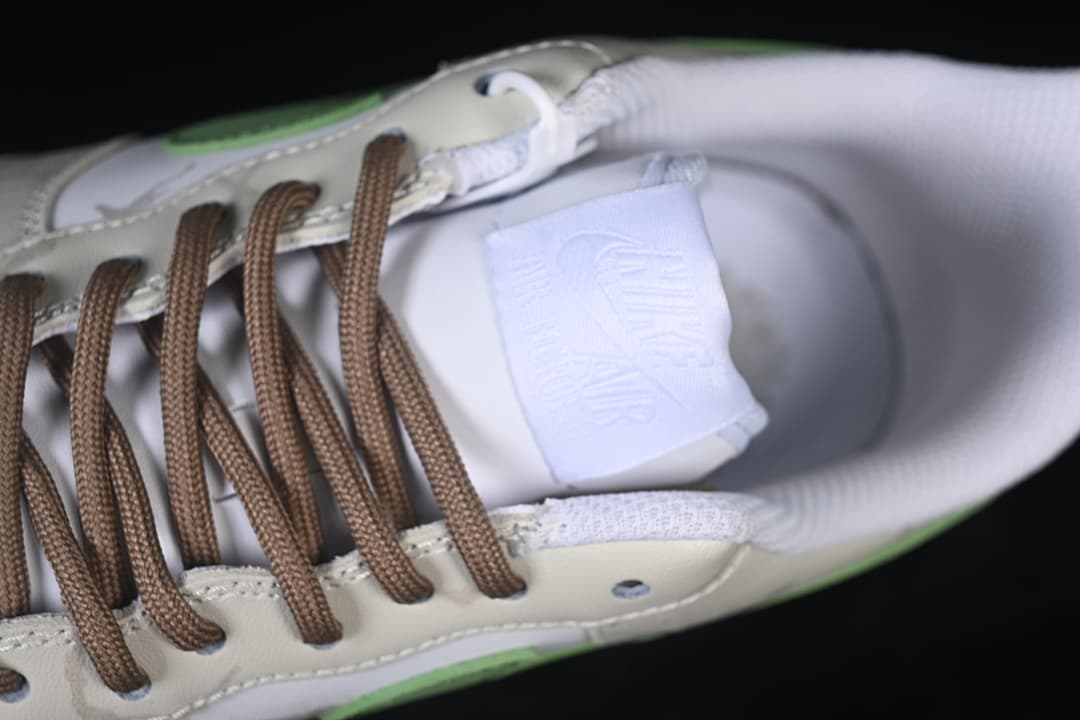 Top detail of the tongue, brown laces, and padded collar