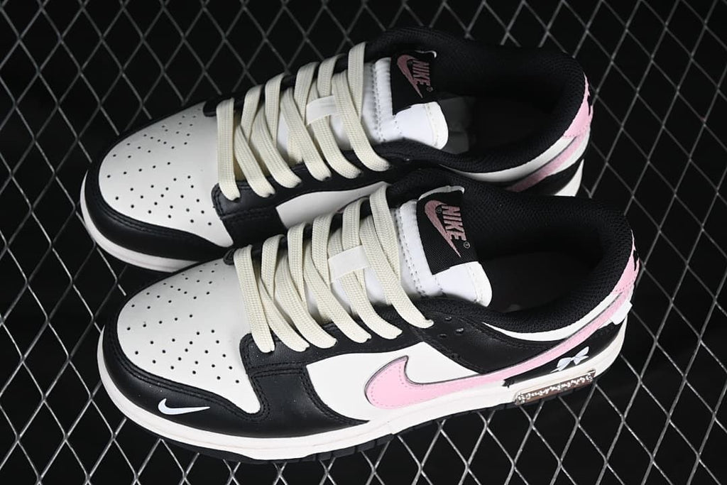 Pair of black, white, and pink low-top sneakers viewed from above