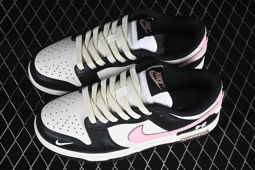 Pair of black, white, and pink low-top sneakers viewed from above