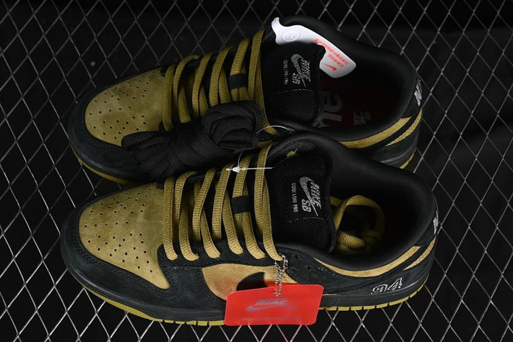 Pair of black and brown-gold low-top sneakers shown from above