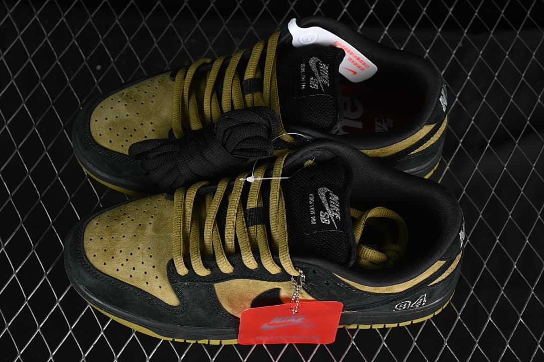 Pair of black and brown-gold low-top sneakers shown from above
