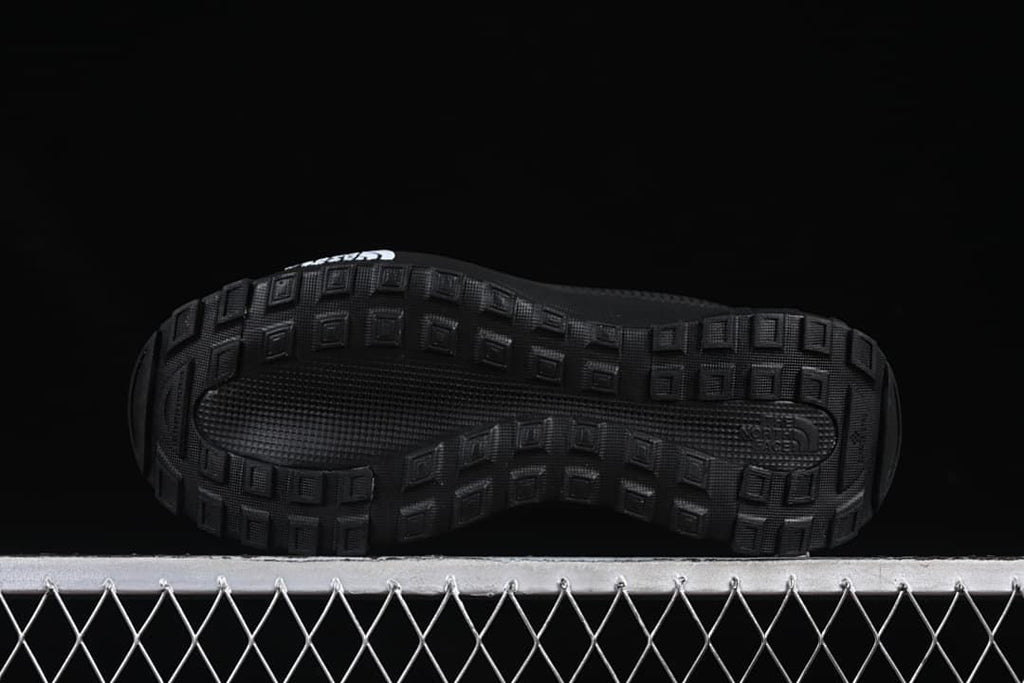 Underside of the shoe showing block-patterned tread