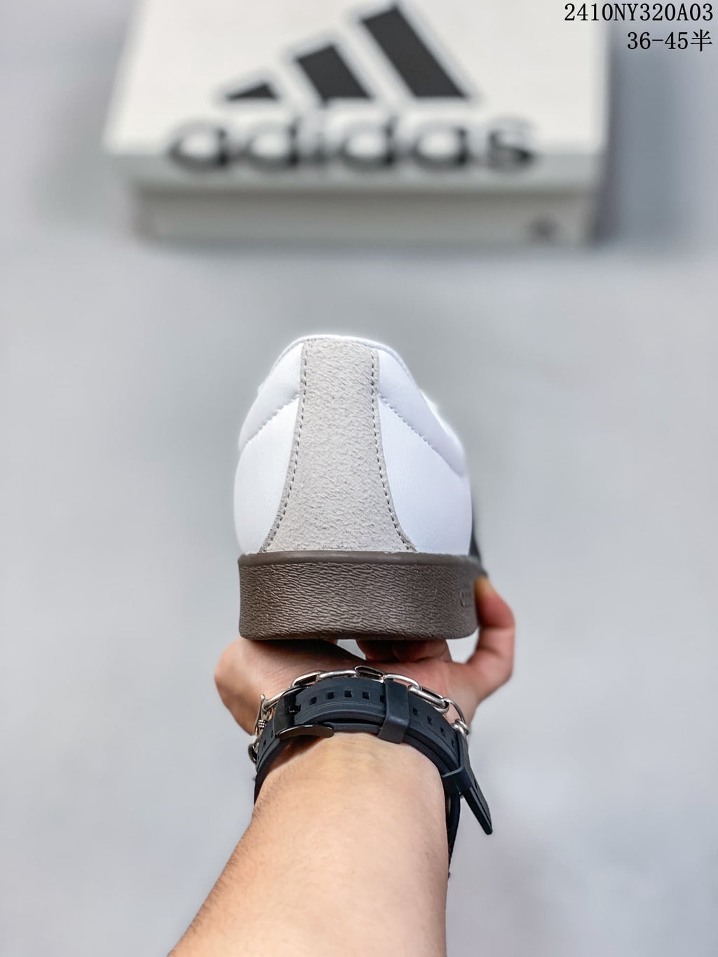 Rear view of the sneaker showing the light-colored heel panel and dark brown sole.