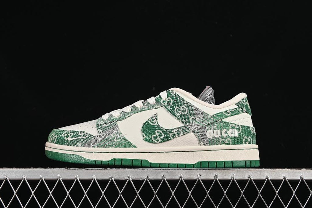 Side view of a cream and green Nike SB Dunk Low sneaker with patterned overlays and a green outsole