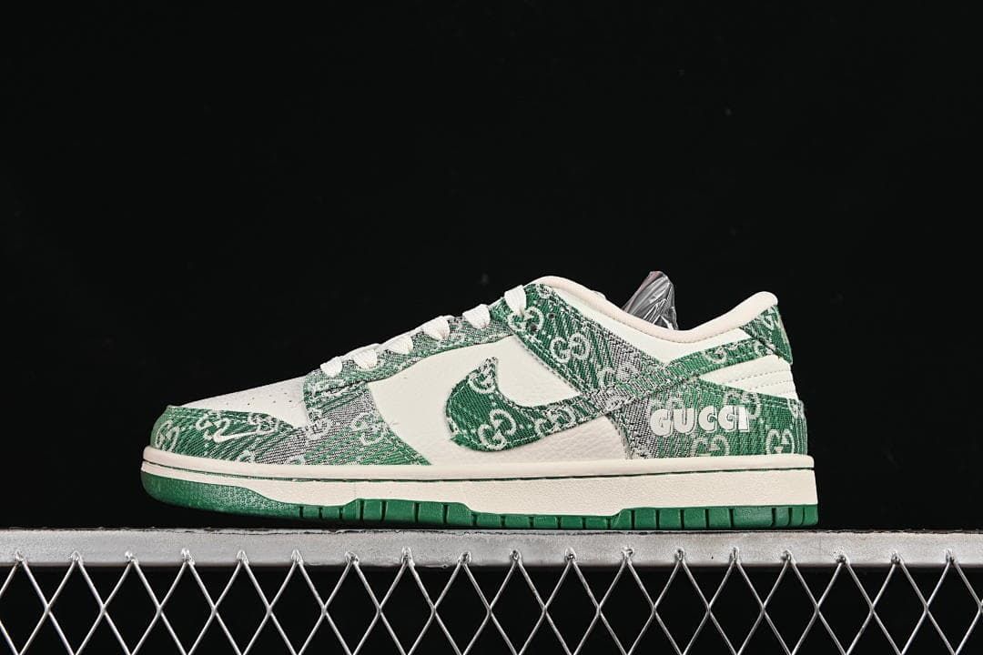 Side view of a cream and green Nike SB Dunk Low sneaker with patterned overlays and a green outsole