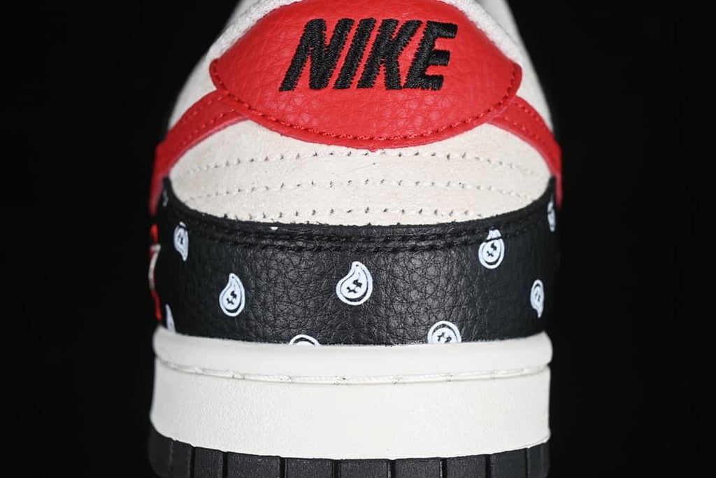 Rear view showing the red heel tab, black paisley-patterned panel, and white midsole.