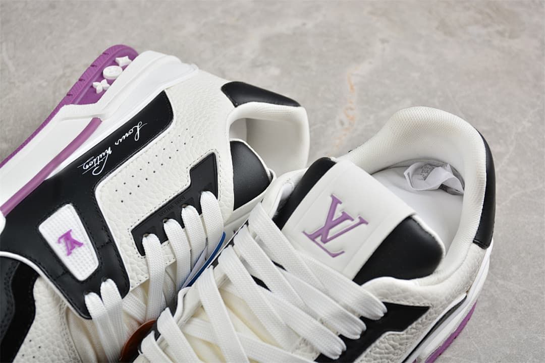 Close-up of the sneakers showing tongue and side branding, laces, and purple accents