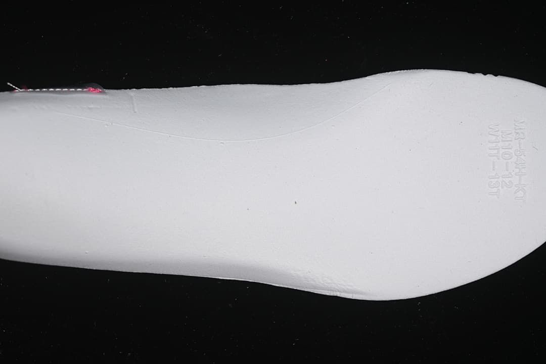 Close-up of the white shoe midsole with molded size and production markings.