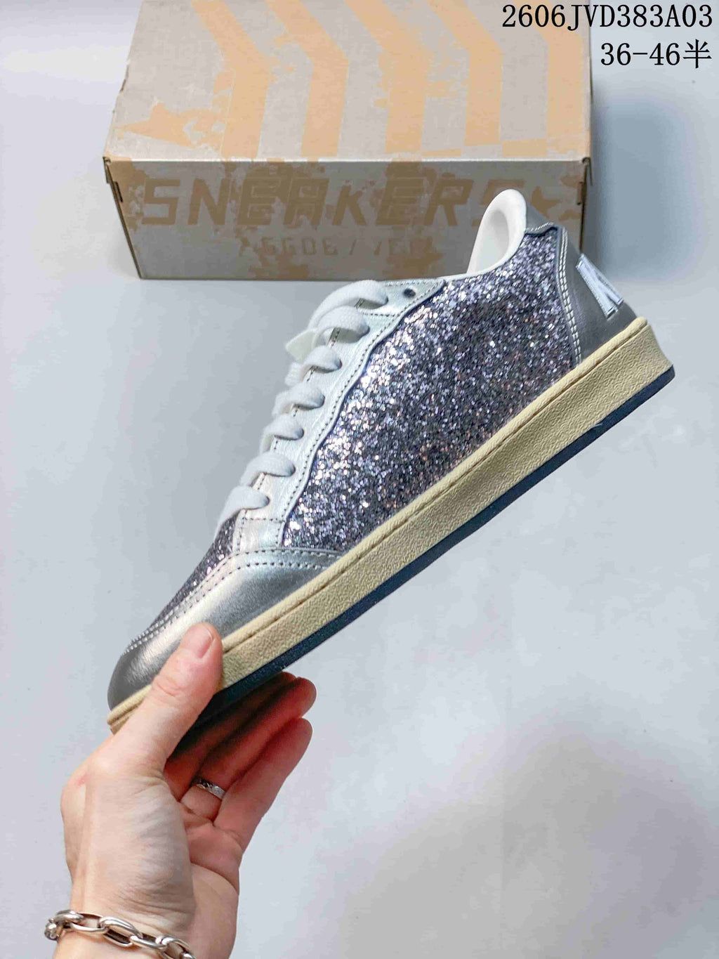 Side profile of a sneaker with glitter panels and silver-tone accents