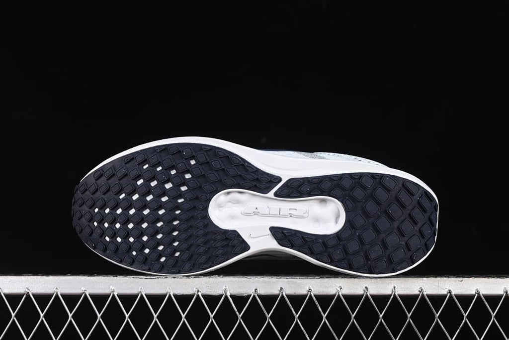 Underside view showing the dark patterned outsole and white central section