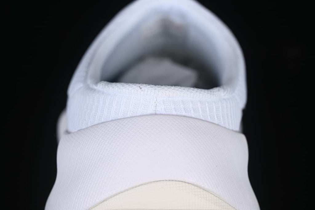 Rear view of the white slip-on shoe and heel construction