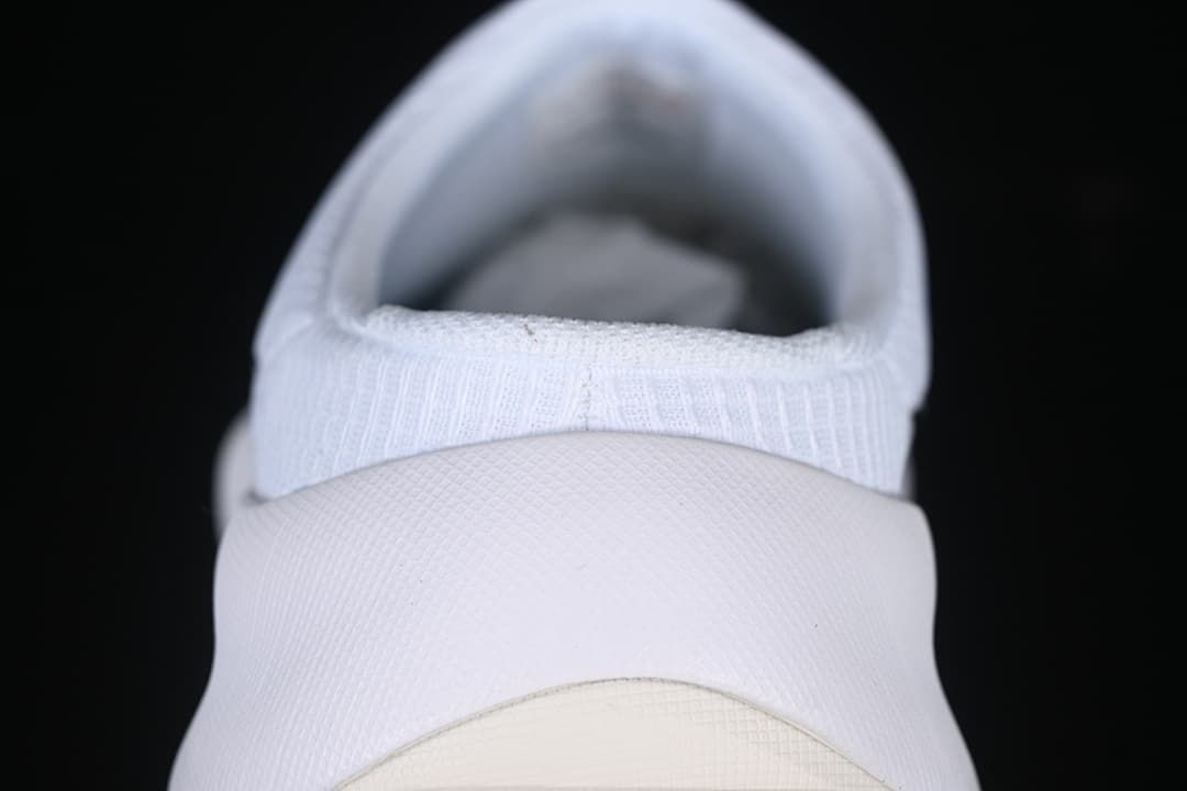 Rear view of the white slip-on shoe and heel construction