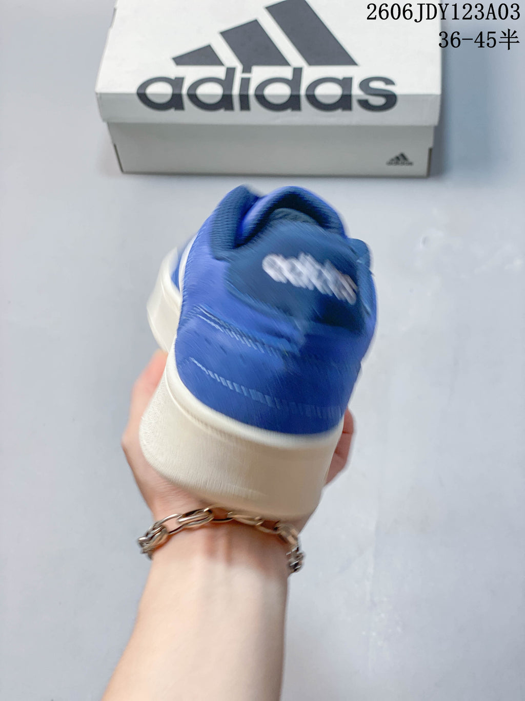 Rear view of the blue sneaker with an off-white sole