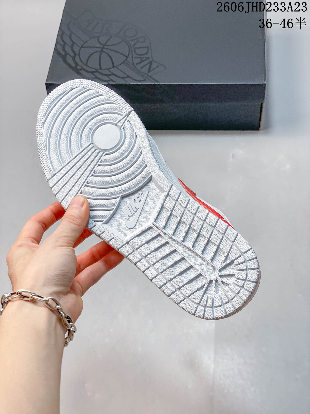 Textured outsole of a red and white low-top sneaker