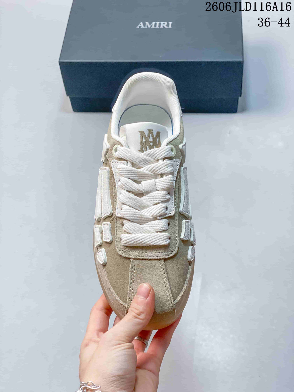 Top view showing white laces, beige-toned panels, and white bone-shaped side details.
