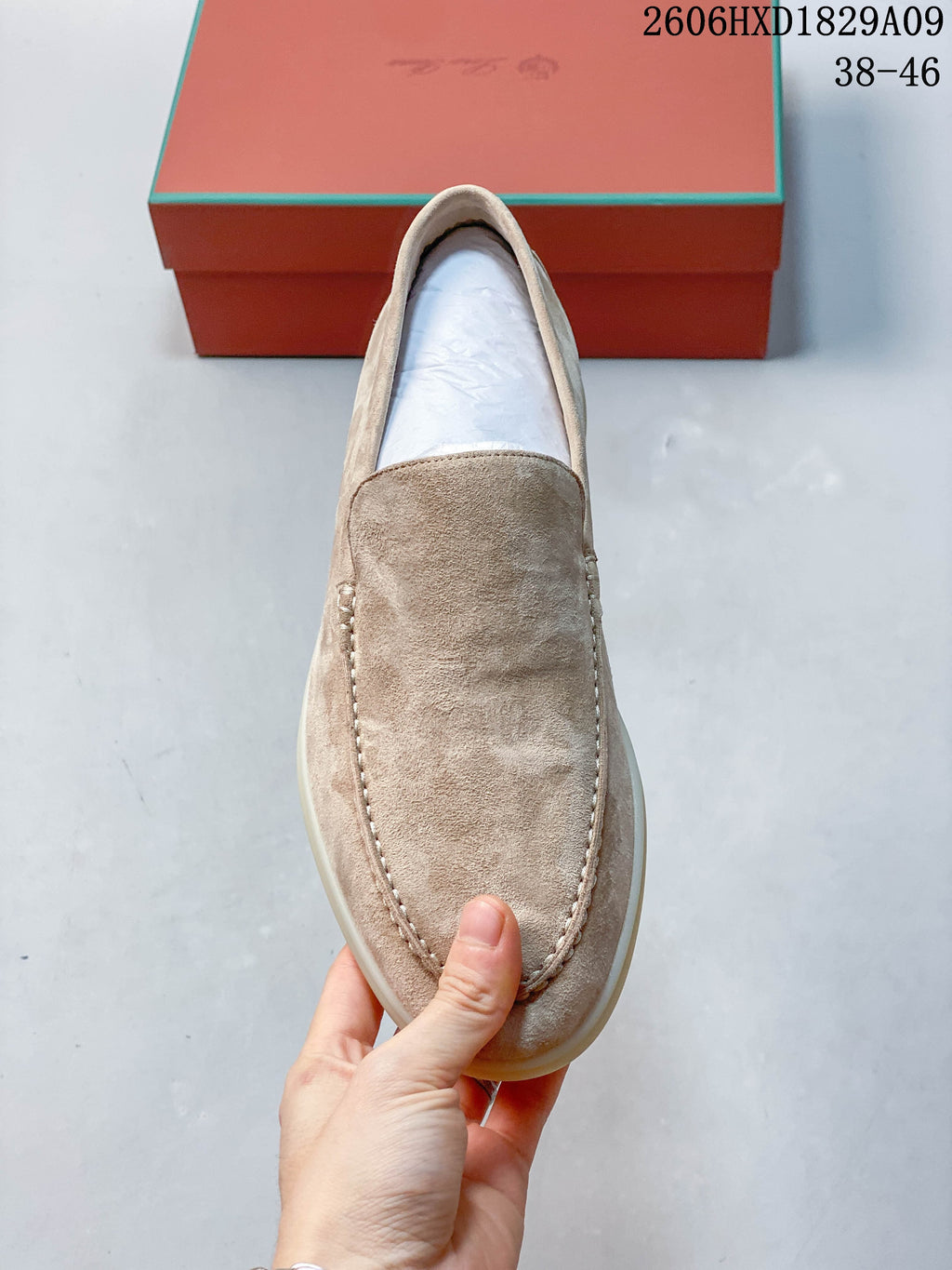 Top view of a beige loafer showing its stitched apron toe
