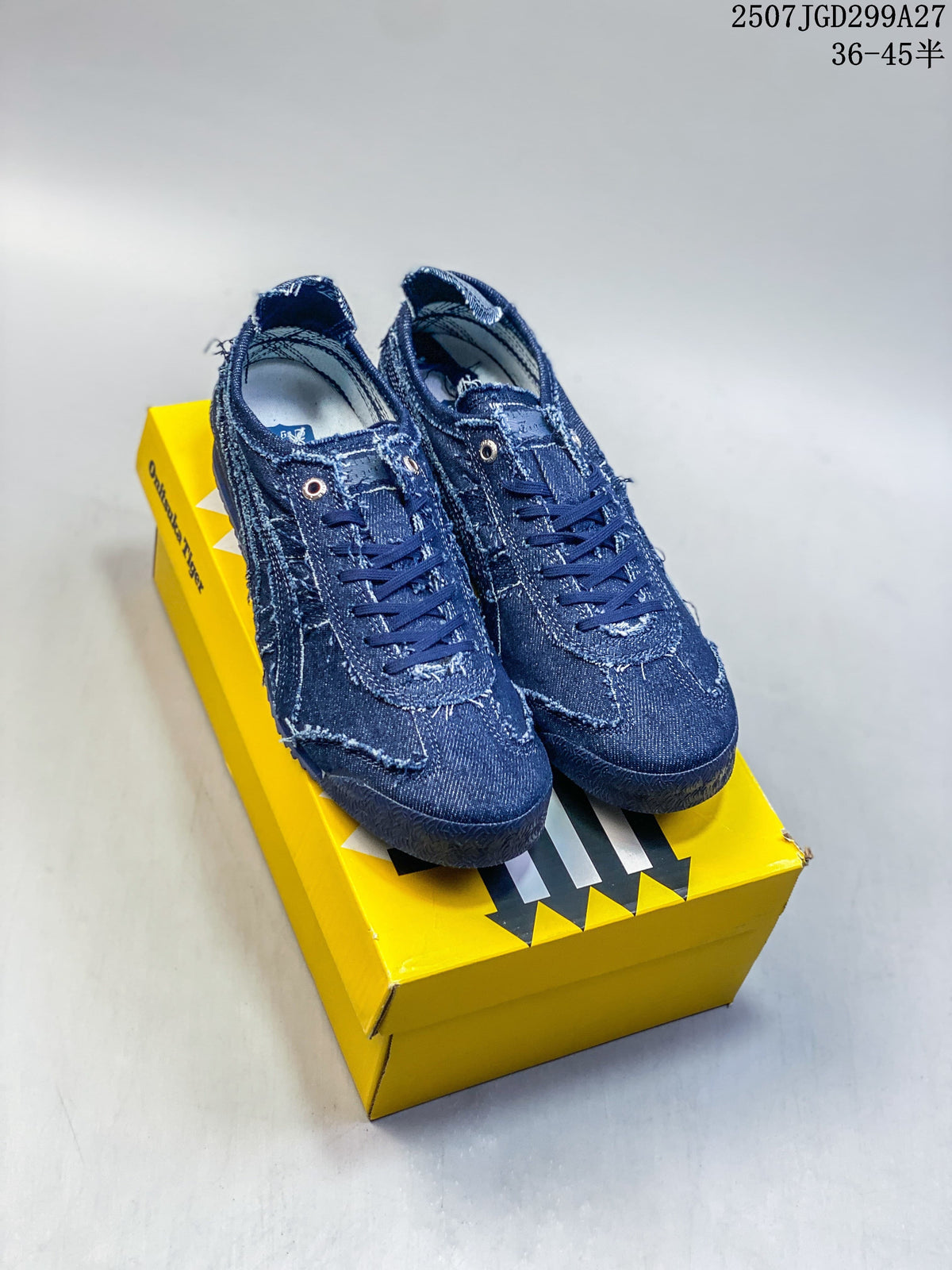 Pair of dark blue distressed denim-look Mexico 66 SD Paraty sneakers on a yellow shoebox
