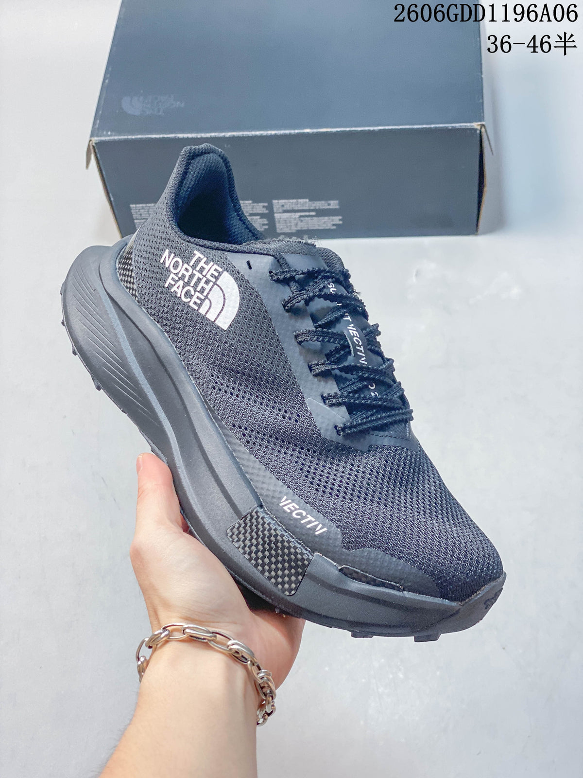 Side view of a gray mesh The North Face sneaker with dark laces and patterned outsole.