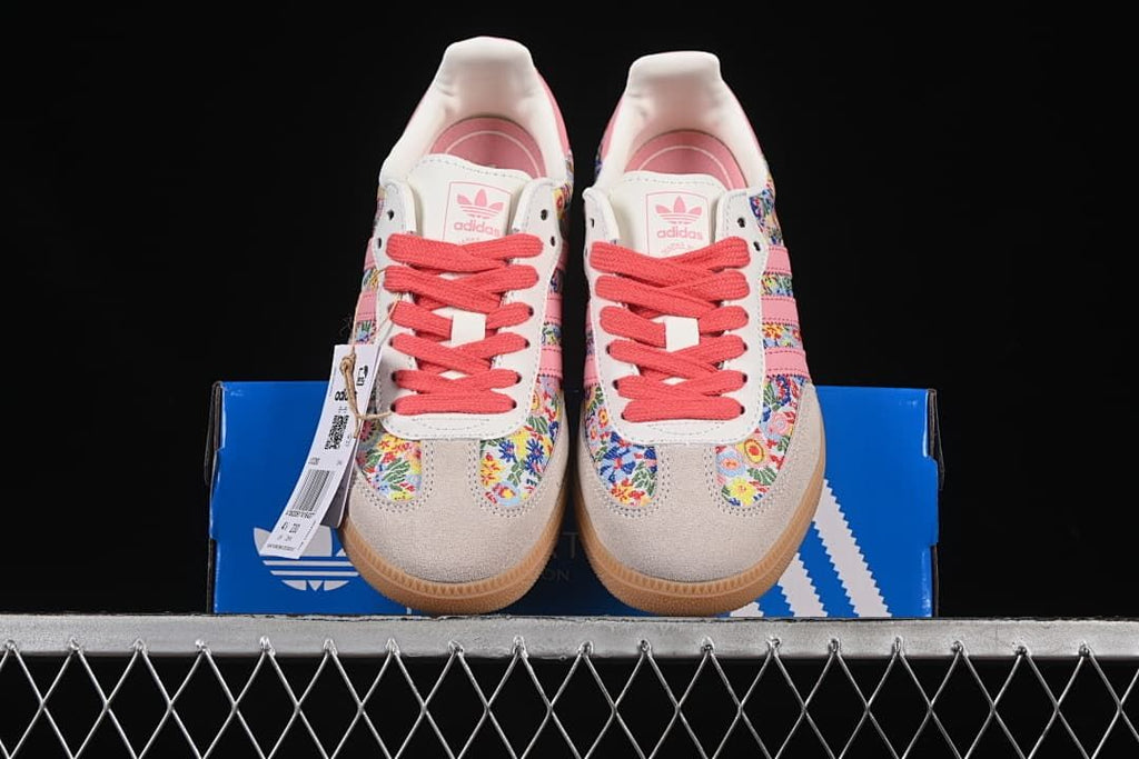 Front view of both floral sneakers on the blue box.